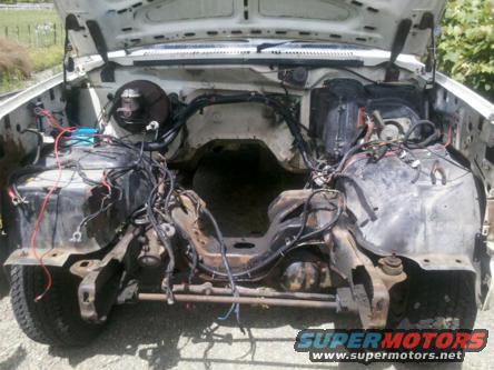 1982 Ford Bronco engine bay with engine removed, showing wiring and frame