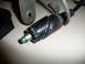 1993 Mazda MX-3 - A close-up view of a black plastic automotive part with a green LED light and a metal bracket.
