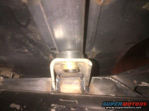 Underbody frame mount with rubber bushing and metal bracket
