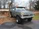 1979 Ford Bronco - This lifted 1978 Ford Bronco is parked on an asphalt driveway with trees in the background.