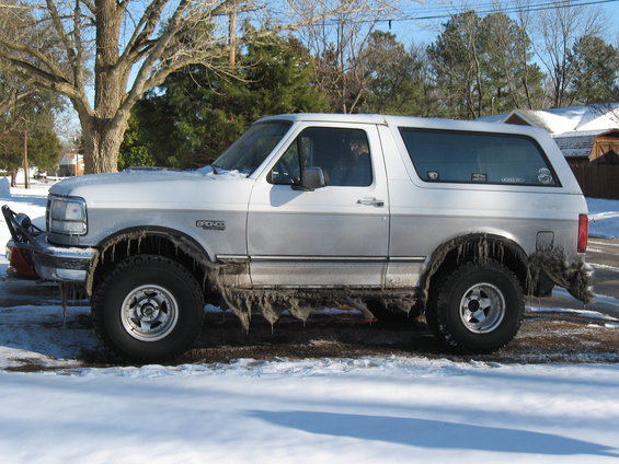 1994 Ford Bronco parked in snow, covered in icicles