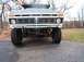 1979 Ford Bronco - The front grille of a 1979 Ford Bronco is visible, prominent F O R D lettering and large tires.