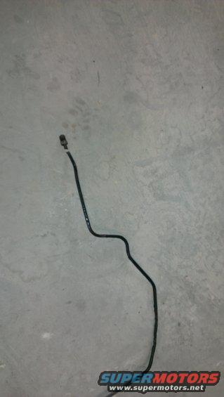 Black brake line with a connector on a gray concrete floor