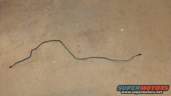 Bent metal brake line on a concrete floor
