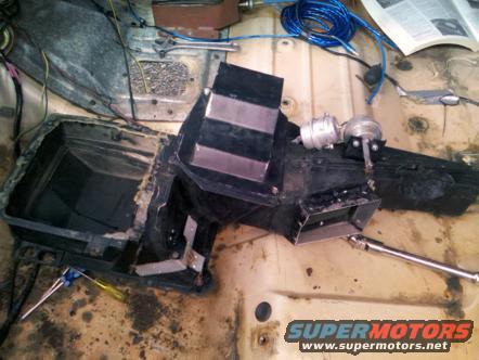 Heater core assembly with vacuum actuator and ducting