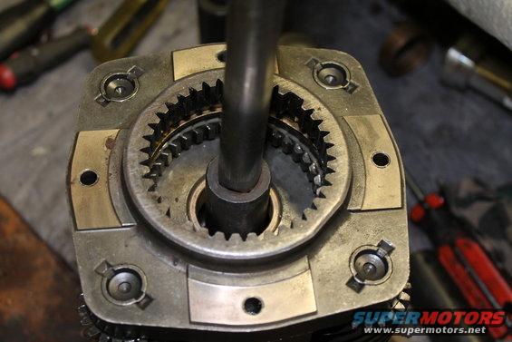Close-up of a transfer case gear assembly with a metal rod inserted