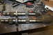1995 Ford Bronco - Two transfer case shafts are laid out on a workbench, surrounded by tools and rags.
