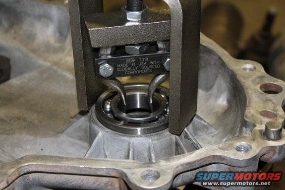 Transfer case bearing being removed with a puller tool