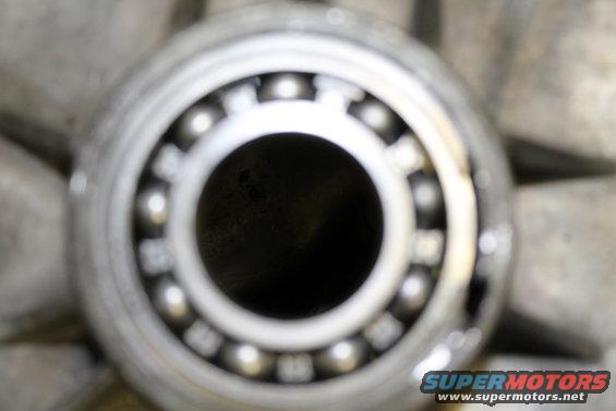 Close-up of a ball bearing with metal balls inside a race