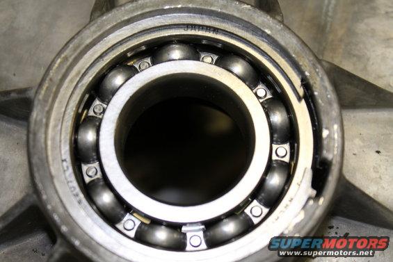 Close-up of a ball bearing with 'JAPAN' visible on the inner race, set within a metal housing