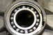 1995 Ford Bronco - A ball bearing, marked 'JAPAN', is shown installed in a metal component, likely part of a drivetrain.