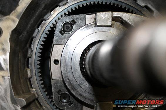 Close-up of transfer case gears and shaft, Supermotors.net logo visible