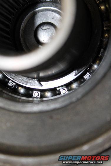 Close-up of a transfer case bearing with visible ball bearings and metal housing
