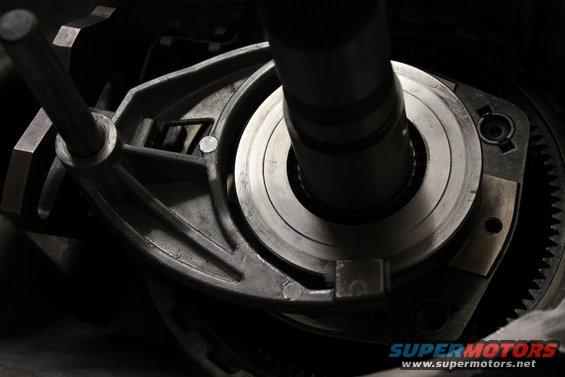 Close-up of a metal gear and housing assembly, likely part of a vehicle's transfer case