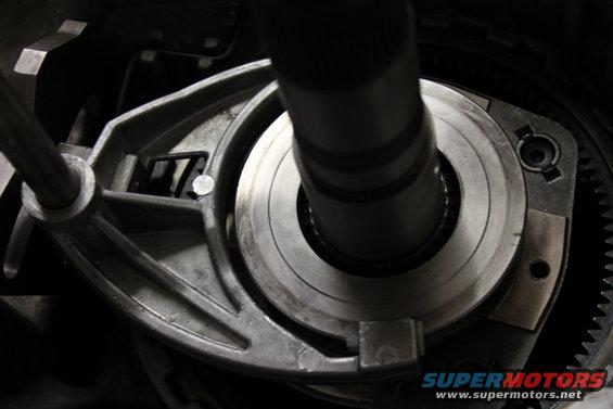 Close-up of a vehicle's transfer case internal mechanism, showing gears and a shaft