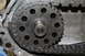 1995 Ford Bronco - This image shows a close-up view of a transfer case chain and gear, with the word 'REAR' stamped on the gear.