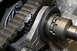 1995 Ford Bronco - Close-up of a transfer case chain, gears, and splined shaft, with Supermotors.net logo visible.