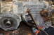 1995 Ford Bronco - Transfer case assembly with linkage and a wrench visible.
