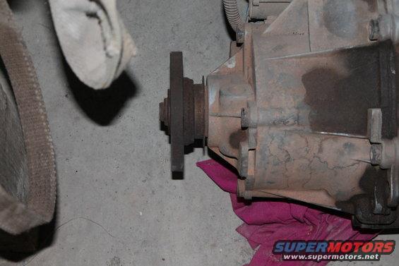 Close-up of a rusty transfer case with a flange attached