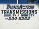 1997 Dodge 3500 - A sign advertises 'Transaction Transmissions' with a phone number and a promise of quality and honesty.