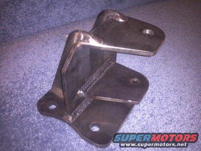 Metal bracket with welds, on a blue textured surface