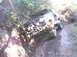 1992 Ford Bronco - Off-roading adventure on a muddy trail with multiple vehicles traversing the difficult terrain.