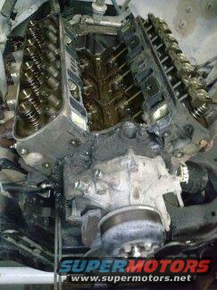 Engine block with valve covers removed. Supermotors.net logo visible