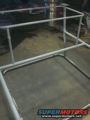 White painted metal roll cage frame on concrete floor