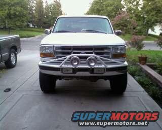 White Ford Bronco front view with aftermarket bumper and fog lights