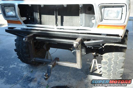 1979 Ford Bronco front end with custom rear bumper and hitch installed, vehicle on jack stands