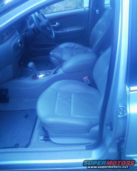 Car interior showing front seats, dashboard, and gear shifter