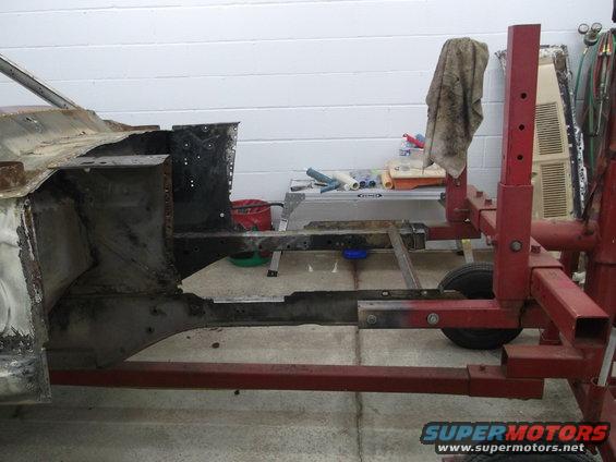 1967 Ford Mustang frame on a red stand