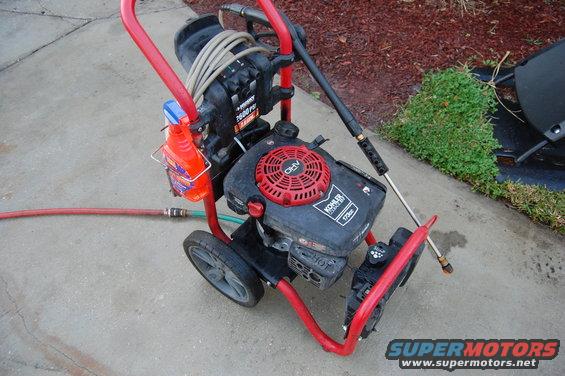 Red frame pressure washer with Kohler engine and hose