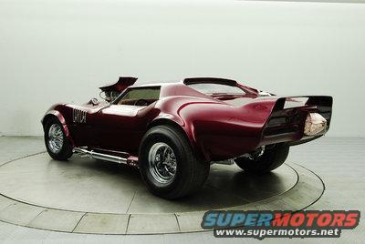 Maroon 1976 Chevrolet Corvette with exposed engine and custom spoiler, rear 3/4 view