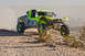 1996 Ford Bronco - Off-road race truck with number 7217 navigates a dusty desert terrain.