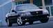 2001 Ford Crown Victoria - This black Mercury Grand Marquis features chrome wheels and a prominent grille, suggesting a model year around 2003.