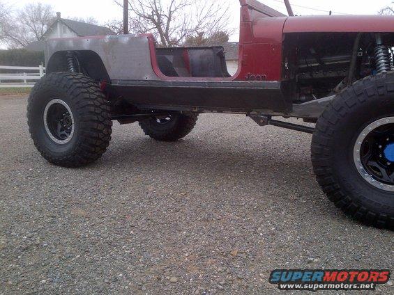 1985 Jeep CJ7 body, unfinished, with large off-road tires and suspension visible
