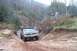 1979 Ford Bronco - A 1975 Ford F-Series truck navigates a challenging, muddy off-road course.