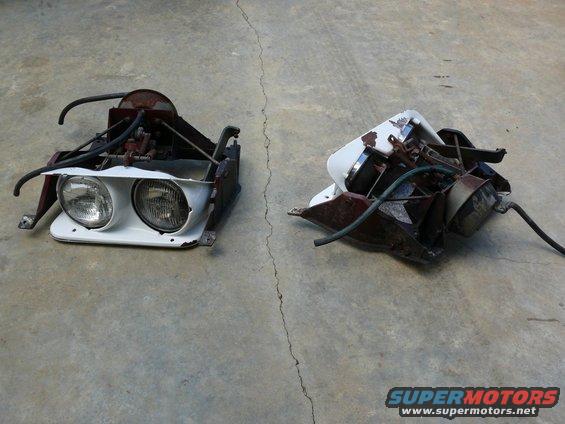 Two car headlight assemblies, one with dual headlights, on a concrete surface