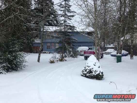 1992 Ford F-150 pickup truck parked in a snowy driveway with other vehicles