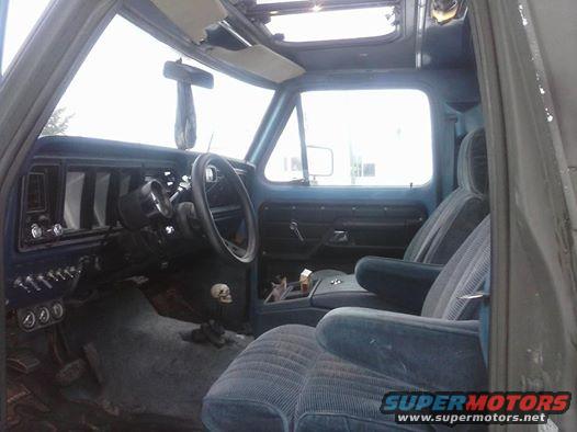 1979 Ford Bronco interior showing blue seats, dashboard, and steering wheel