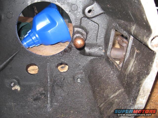 Bell housing interior with blue funnel and copper-colored pin