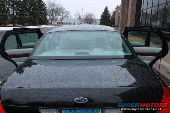 Black 2005 Ford Crown Victoria rear view with doors open
