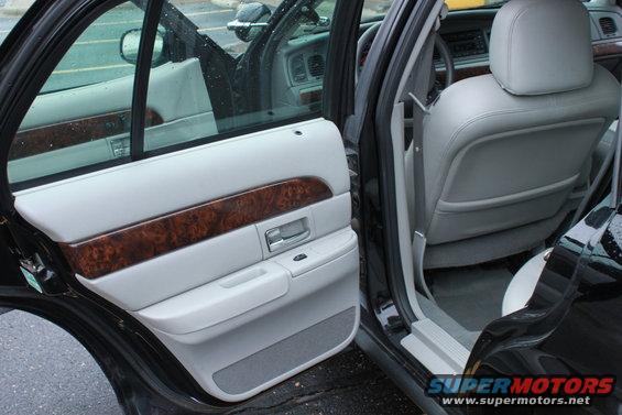 2005 Ford Crown Victoria interior showing front passenger door panel and rear seat