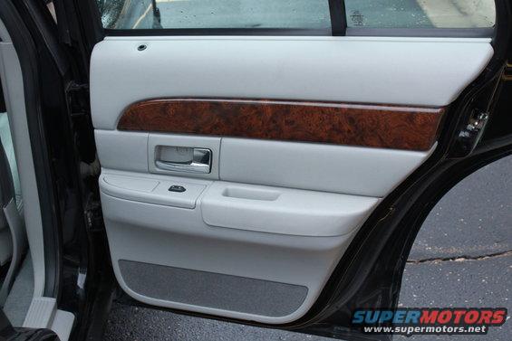 Interior door panel with wood trim and chrome handle