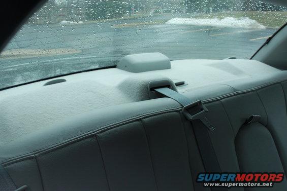 Back seat and rear window of a car, it's raining outside