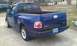 2003 Ford F-150 - This blue 2003 Ford F-150 SVT Lightning pickup truck is shown from the rear 3/4 angle.