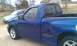 2003 Ford F-150 - Side view of a blue 2003 Ford F-150 Lightning pickup truck.