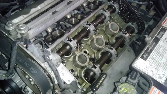 Engine with camshafts exposed, Ford Motor Company label visible