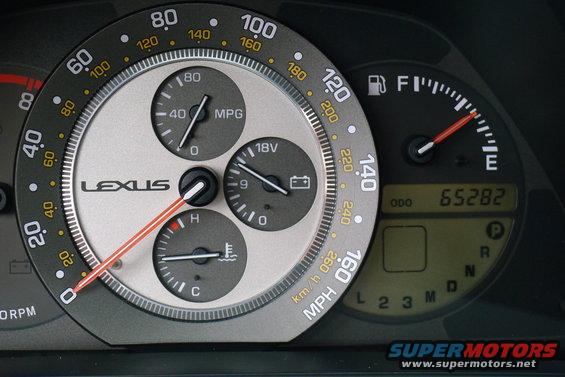 Lexus IS 300 dashboard with speedometer, tachometer, fuel, temperature, and battery gauges. Odometer shows 65282